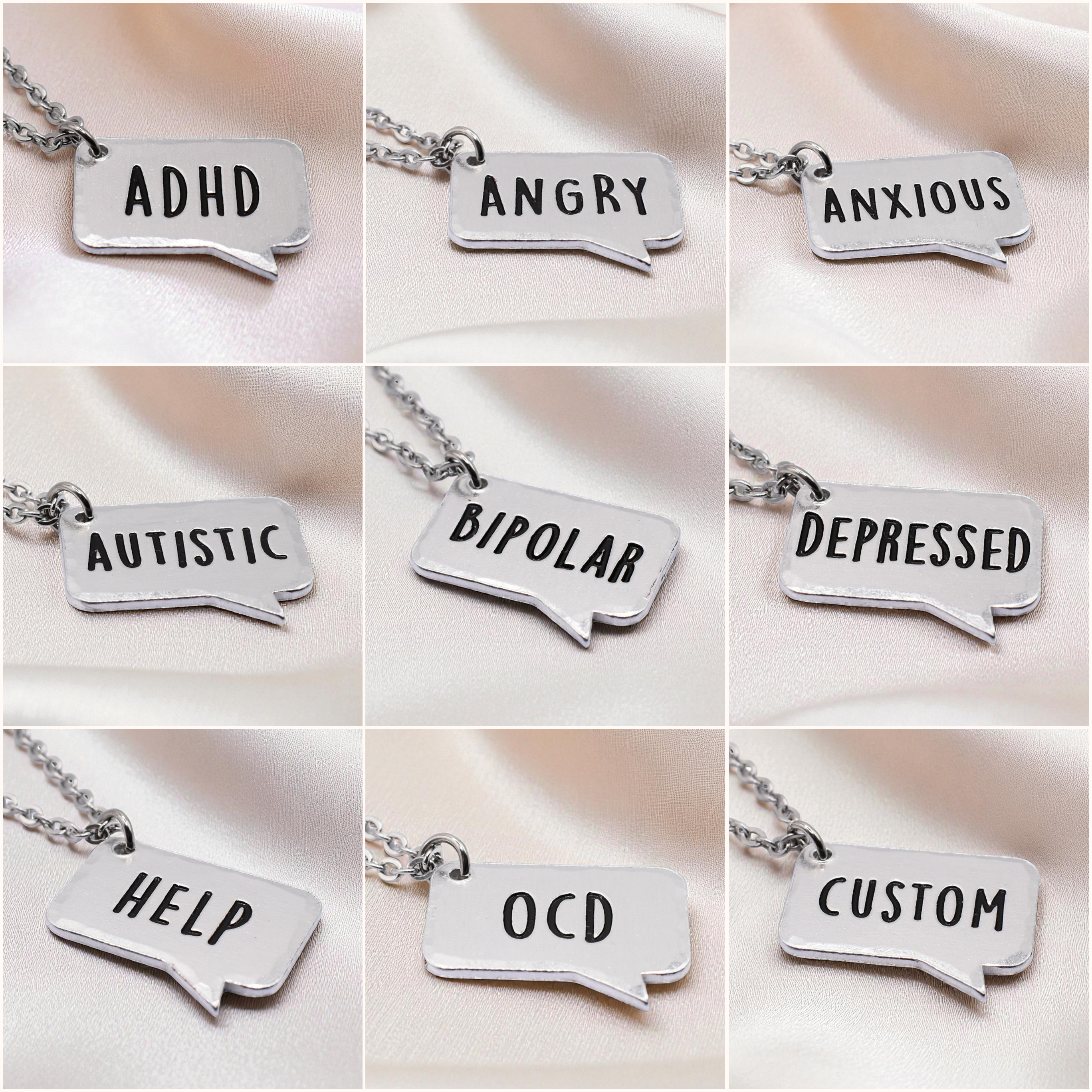 Collection of silver necklaces with speech bubble pendants displaying various labels.