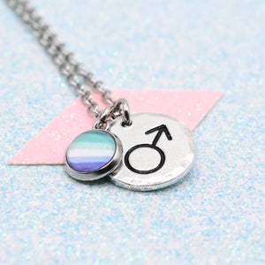 MLM Pride Necklace with a gender symbol charm on a light blue and pink background