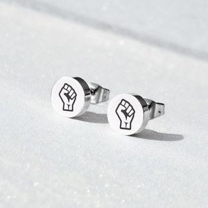 Pair of earring studs with Resist Fist Logo on blue background
