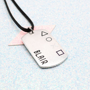 Asexual pride coloured Dog tag necklace with personalised name and gaming symbols on a light blue background - On a faux leather cord