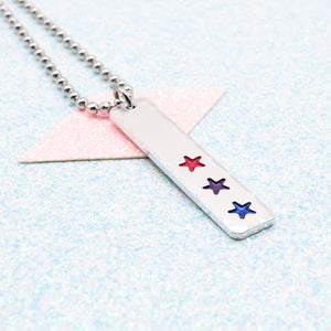 LGBTQ+ bisexual Necklace bar pendant featuring colourful star designs representing the bisexual pride flag on a light blue background on a Ball Chain