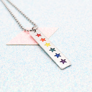 LGBTQ+ Rainbow Necklace bar pendant featuring colourful star designs representing the traditional pride flag on a light blue background on a Ball Chain
