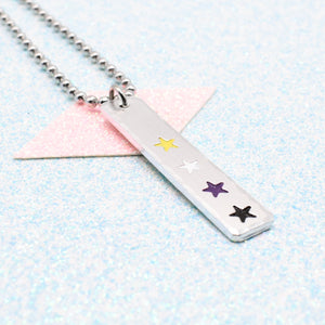 LGBTQ+ non binary Necklace bar pendant featuring colourful star designs representing the non binary pride flag on a light blue background on a Ball Chain