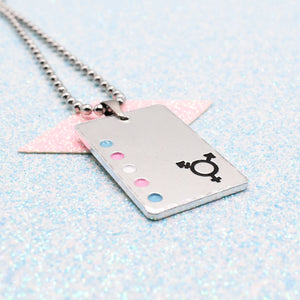 Transgender Necklace with a rectangular tag featuring a transgender symbol and accents on a light blue background