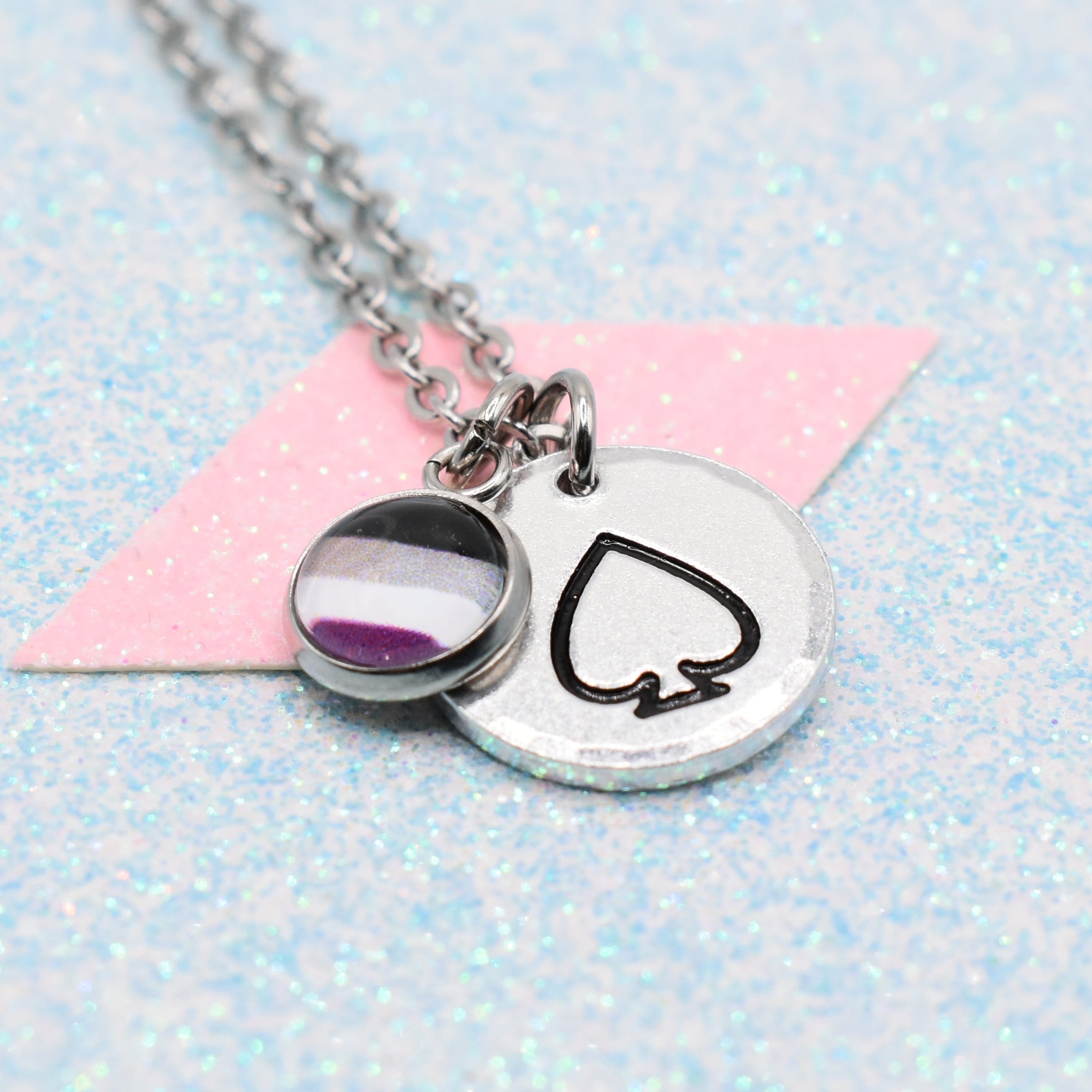 Necklace with an asexual pendant featuring a asexual pride flag on a light blue and pink gradient background.