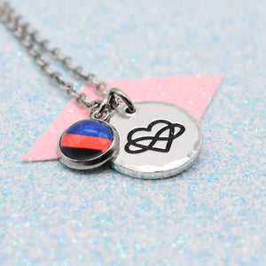 Polyamory Pride Necklace with two charms on a light blue glittery background