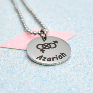 A silver-colored bisexual pride necklace with a pendant featuring a bisexual emblem and the name 'Azarih' written below it, on a blue glittery background.