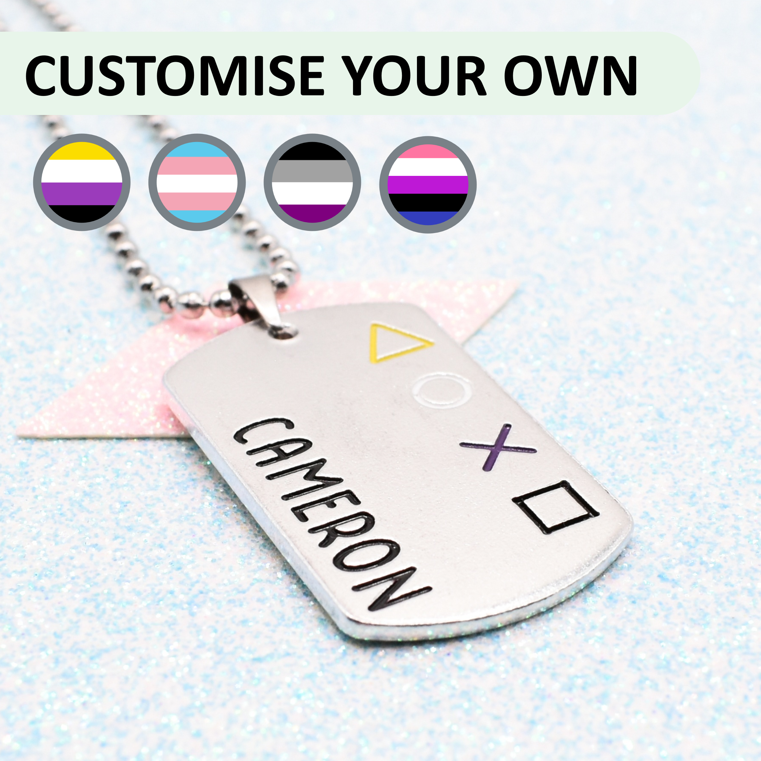 Personalized dog tag with 'Cameron' engraved, featuring gender pride flag designs on a light blue background.