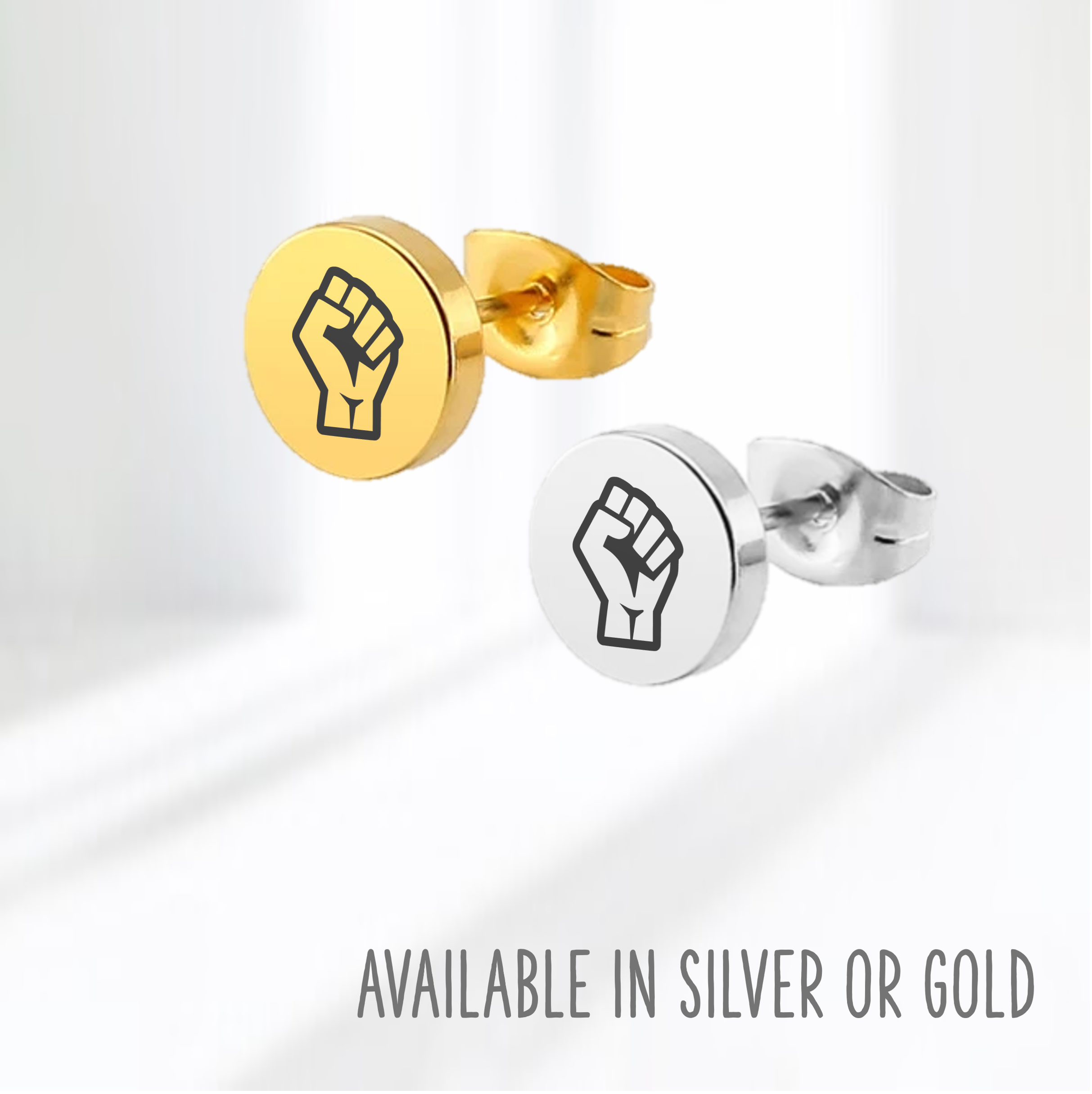 Pair of earring studs in silver and gold with Resist Fist Logo on blue background