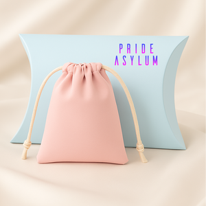 Pink drawstring bag with beige cord in front of a light blue pillow with 'Pride Asylum' text.