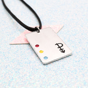 Pansexual Necklace with a rectangular tag featuring a Pansexual symbol and accents on a leather cord displayed on a light blue background