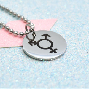 Necklace with a round pendant featuring a transgender symbol on a light blue and pink gradient background